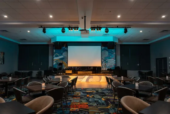 Empty Rapids showroom with stage and screen